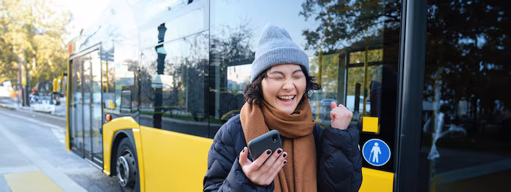 Modern people and lifestyle happy asian girl screams from joy celebrates stands near bus public